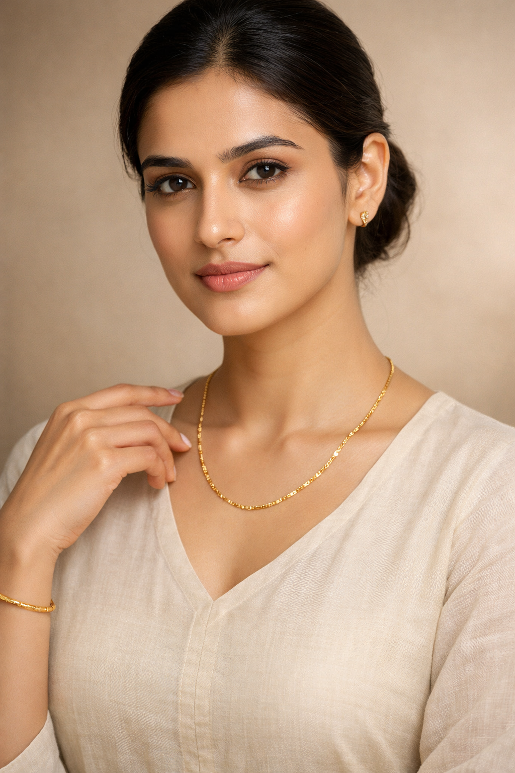 model wearing gold necklace